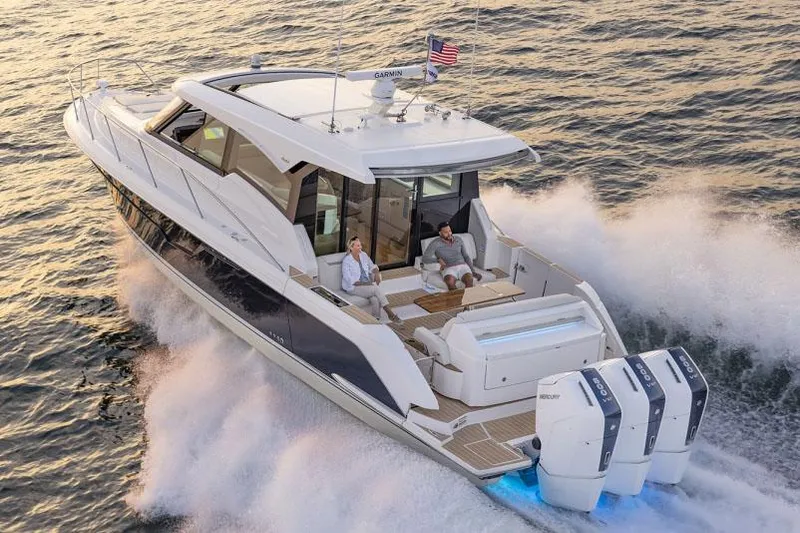  Yacht Photos Pics Manufacturer Provided Image: 2025 Tiara Yachts 48 LE cruising on water with passengers, showcasing luxury and performance.