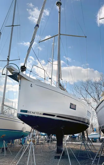 Betwixt Yacht Photos Pics Beneteau Oceanis 51.1 sailboat, 2022 model, displayed on stands under a clear sky.