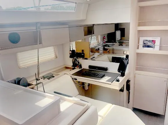 Betwixt Yacht Photos Pics Modern interior of 2022 Beneteau Oceanis 51.1 yacht with sleek design and workspace.