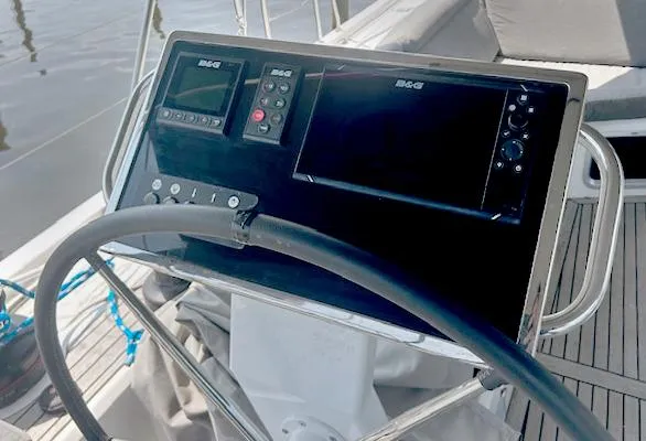 Betwixt Yacht Photos Pics Steering console of 2022 Beneteau Oceanis 51.1 yacht with navigation instruments.