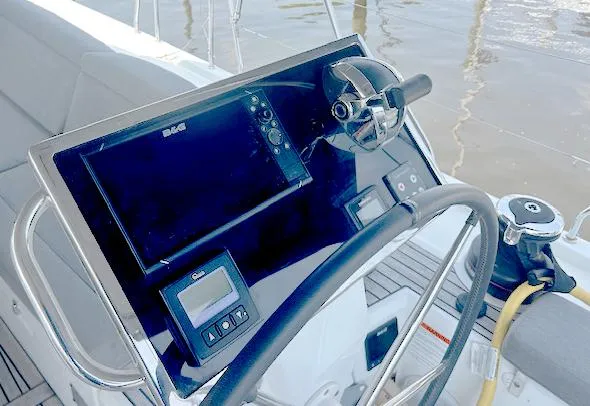 Betwixt Yacht Photos Pics Steering console of 2022 Beneteau Oceanis 51.1 yacht with navigation equipment.