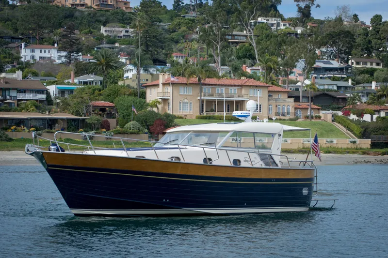 True Grit Yacht Photos Pics 2003 Apreamare 40 yacht cruising near luxurious waterfront homes.