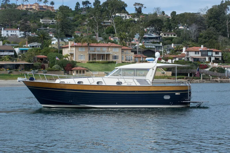 True Grit Yacht Photos Pics 2003 Apreamare 40 yacht cruising near scenic waterfront homes.