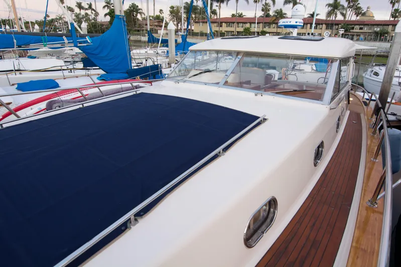 True Grit Yacht Photos Pics 2003 Apreamare 40 yacht docked, featuring sleek design and wooden deck.