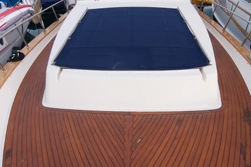 True Grit Yacht Photos Pics Deck of 2003 Apreamare 40 yacht with wooden finish and blue cover.