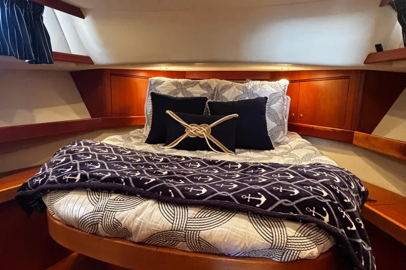 True Grit Yacht Photos Pics Cozy cabin interior of 2003 Apreamare 40 yacht with nautical-themed bedding.