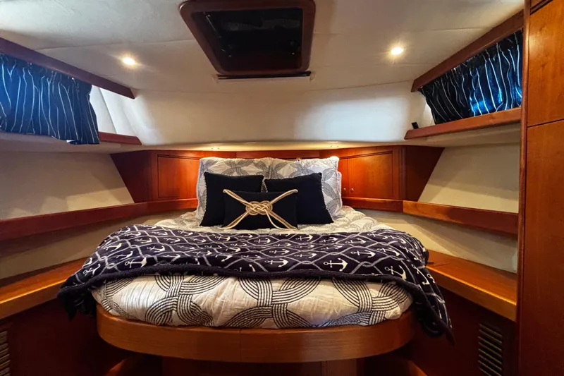 True Grit Yacht Photos Pics Cozy cabin interior of 2003 Apreamare 40 yacht with nautical-themed bedding.