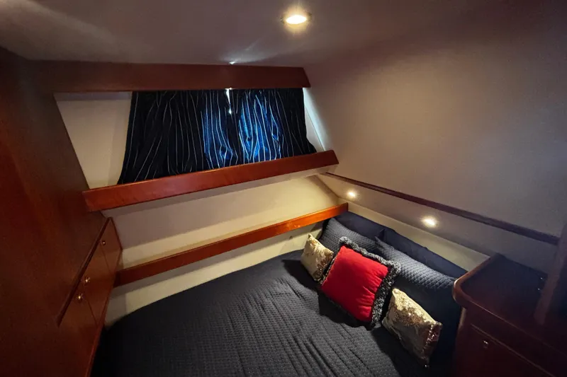 True Grit Yacht Photos Pics Cozy cabin interior of 2003 Apreamare 40 yacht with elegant bedding and ambient lighting.