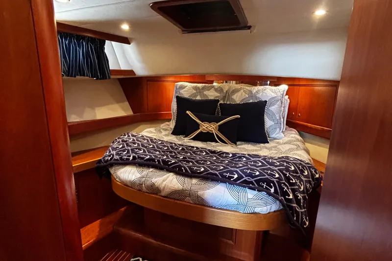 True Grit Yacht Photos Pics Luxurious cabin interior of 2003 Apreamare 40 yacht with cozy bedding and nautical decor.