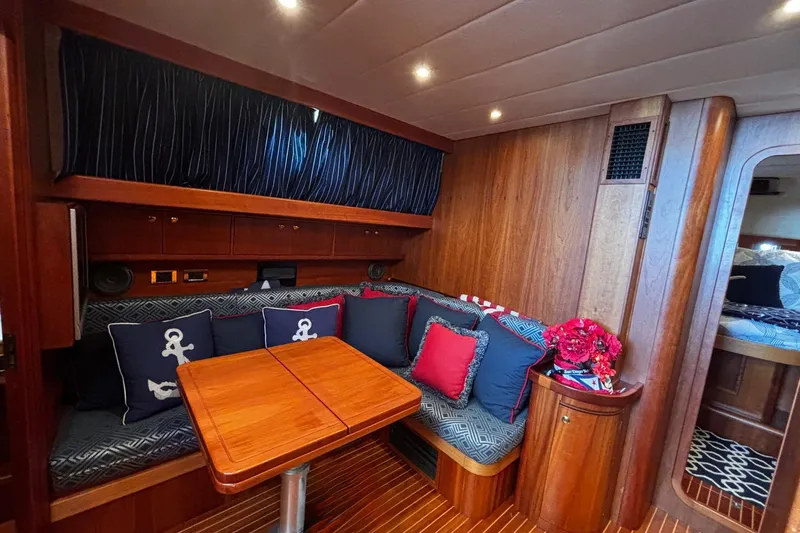 True Grit Yacht Photos Pics Luxurious 2003 Apreamare 40 yacht interior with cozy seating and elegant wooden finishes.