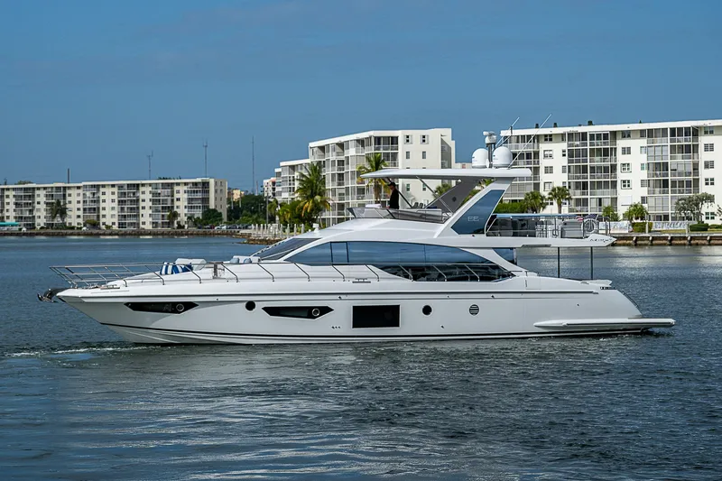 Liquid Asset Yacht Photos Pics 2020 Azimut 66 yacht cruising near waterfront buildings.