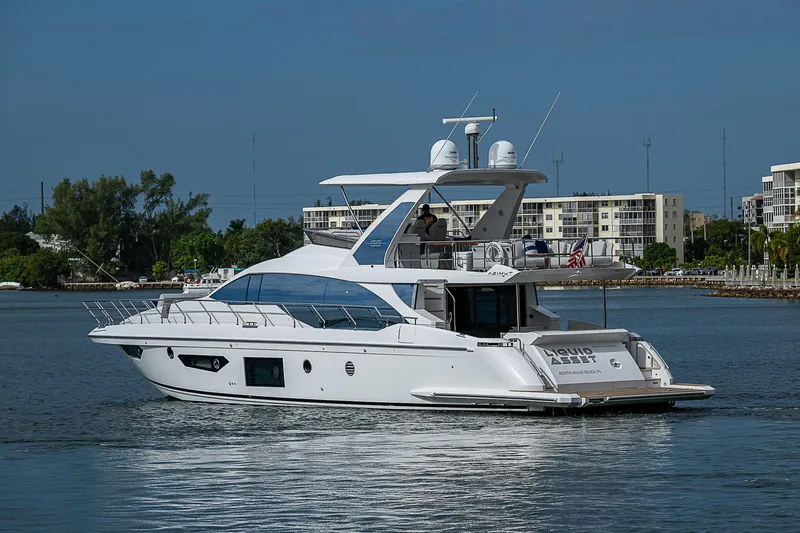 Liquid Asset Yacht Photos Pics 2020 Azimut 66 yacht cruising on a calm waterway.