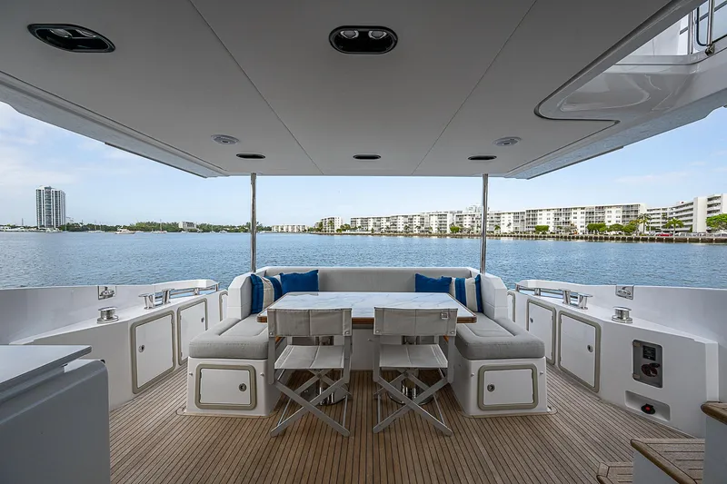 Liquid Asset Yacht Photos Pics Luxurious 2020 Azimut 66 yacht deck with elegant seating and scenic waterfront view.