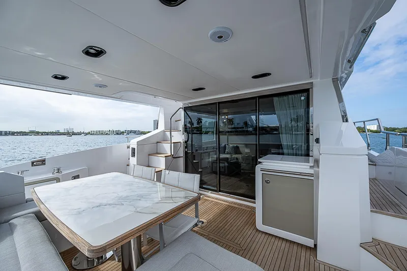 Liquid Asset Yacht Photos Pics Luxurious 2020 Azimut 66 yacht deck with elegant dining area and ocean view.