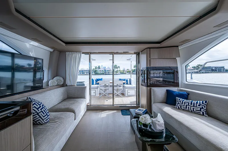 Liquid Asset Yacht Photos Pics Luxurious interior of 2020 Azimut 66 yacht with modern seating and large windows.