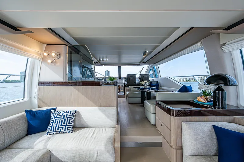 Liquid Asset Yacht Photos Pics Luxurious interior of 2020 Azimut 66 yacht with modern furnishings and panoramic windows.