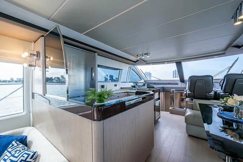 Liquid Asset Yacht Photos Pics Luxurious interior of 2020 Azimut 66 yacht with modern furnishings and panoramic windows.