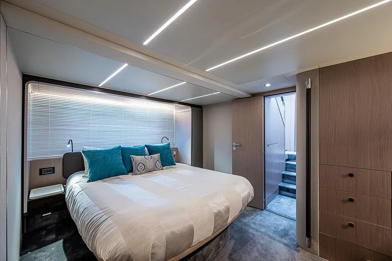 Liquid Asset Yacht Photos Pics Luxurious bedroom interior of 2020 Azimut 66 yacht with modern design and cozy bedding.
