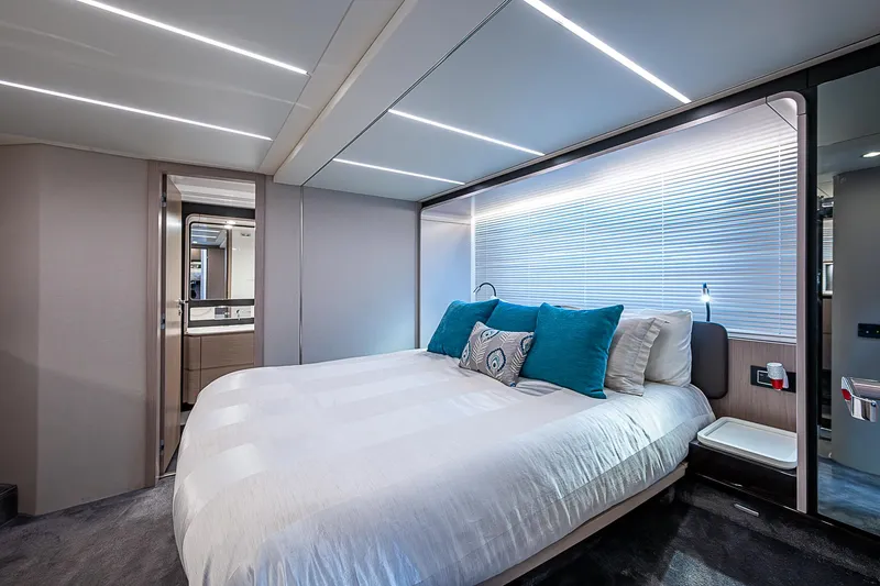 Liquid Asset Yacht Photos Pics Luxurious bedroom interior of 2020 Azimut 66 yacht with modern design and ambient lighting.