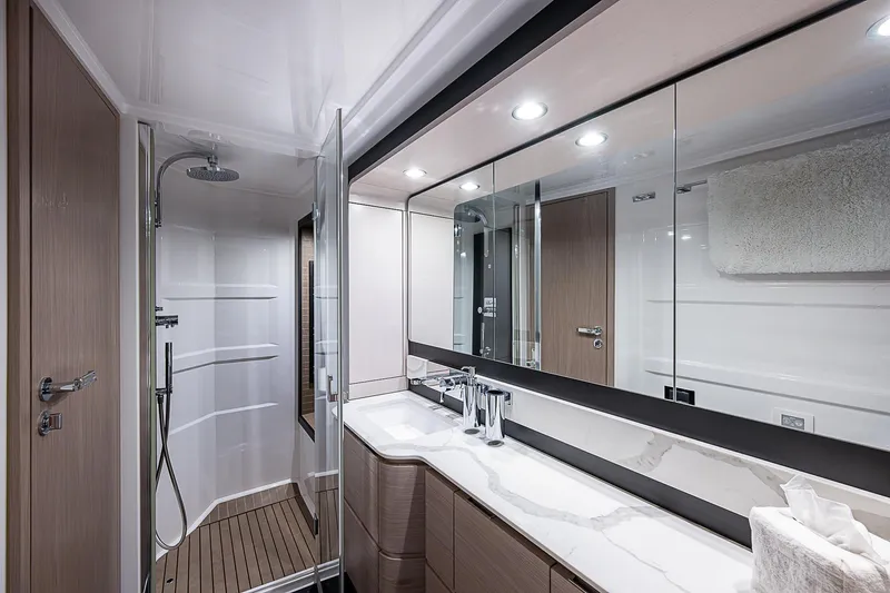 Liquid Asset Yacht Photos Pics Luxurious bathroom in 2020 Azimut 66 yacht with modern fixtures and spacious shower.