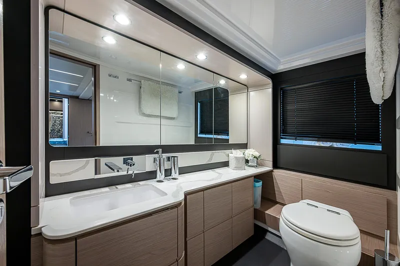 Liquid Asset Yacht Photos Pics Luxurious bathroom interior of 2020 Azimut 66 yacht with modern fixtures and elegant design.