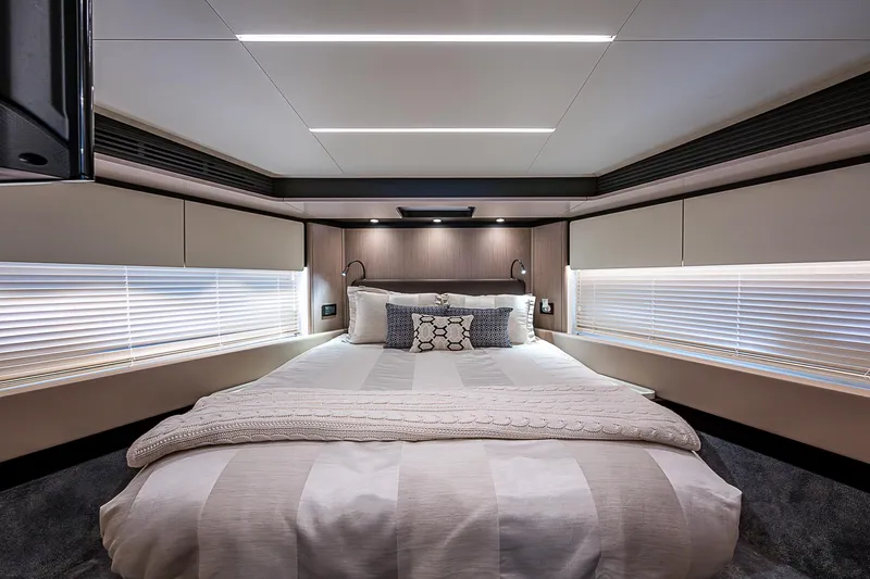 Liquid Asset Yacht Photos Pics Luxurious bedroom interior of 2020 Azimut 66 yacht with modern design and ambient lighting.