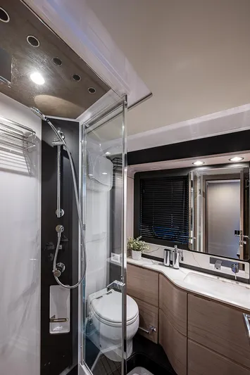 Liquid Asset Yacht Photos Pics Luxurious bathroom in 2020 Azimut 66 yacht with modern fixtures and glass shower.