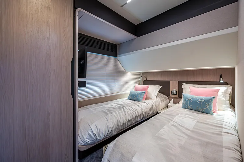 Liquid Asset Yacht Photos Pics Luxurious twin cabin in 2020 Azimut 66 yacht with modern decor and cozy bedding.
