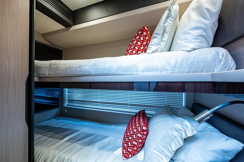 Liquid Asset Yacht Photos Pics Bunk beds in 2020 Azimut 66 yacht cabin with red accent pillows.