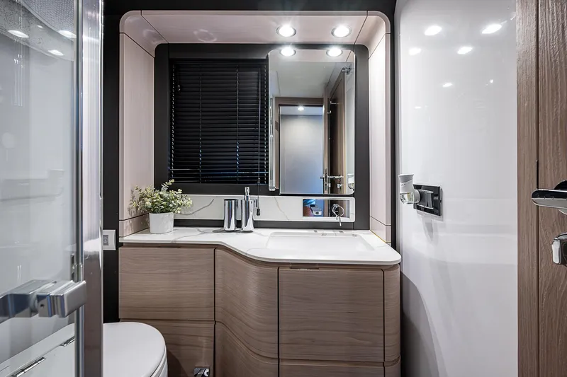Liquid Asset Yacht Photos Pics Luxurious bathroom interior of 2020 Azimut 66 yacht with modern fixtures and elegant design.