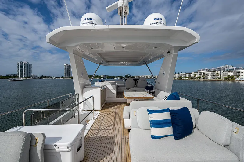 Liquid Asset Yacht Photos Pics Luxurious 2020 Azimut 66 yacht deck with plush seating and scenic waterfront view.