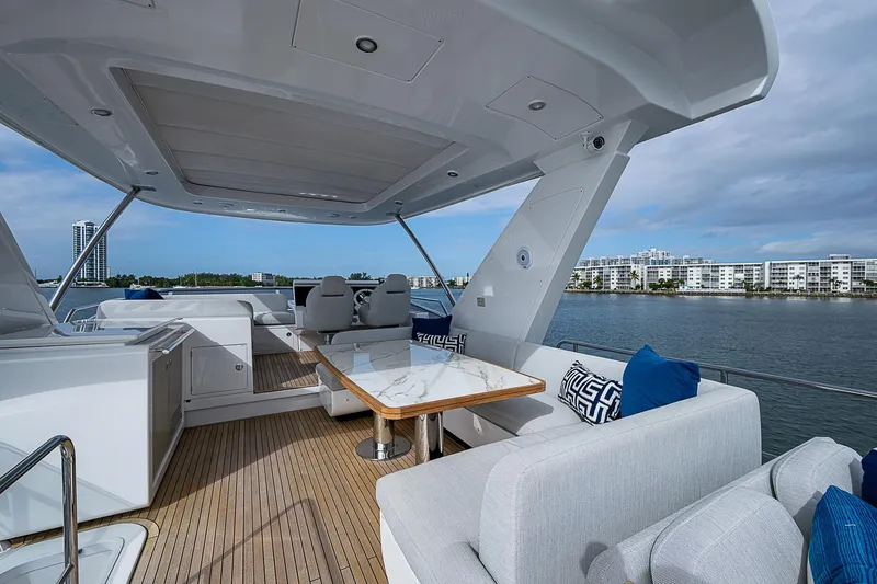 Liquid Asset Yacht Photos Pics Luxurious 2020 Azimut 66 yacht deck with elegant seating and scenic waterfront view.