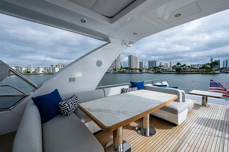 Liquid Asset Yacht Photos Pics Luxurious 2020 Azimut 66 yacht deck with elegant seating and waterfront city view.