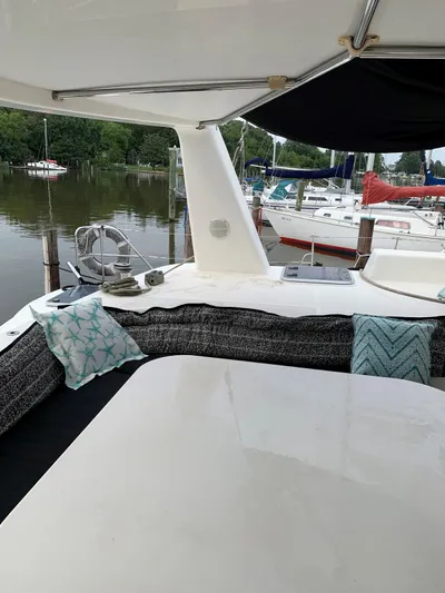 Seapaws Yacht Photos Pics Deck of 1996 Voyage Yachts 470 with seating area and marina view.