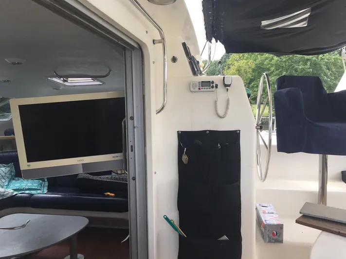 Seapaws Yacht Photos Pics Interior of a 1996 Voyage Yachts 470, featuring a TV, seating, and navigation equipment.