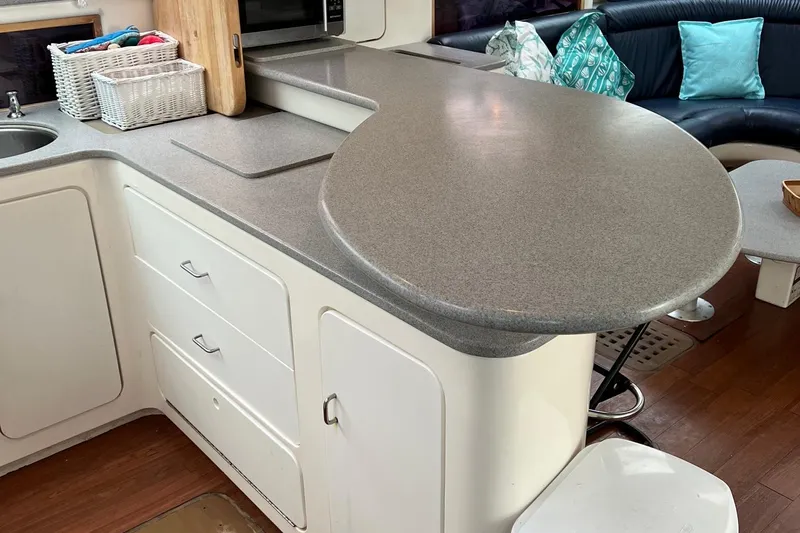 Seapaws Yacht Photos Pics Modern kitchen area in a 1996 Voyage Yachts 470, featuring sleek countertops and ample storage.