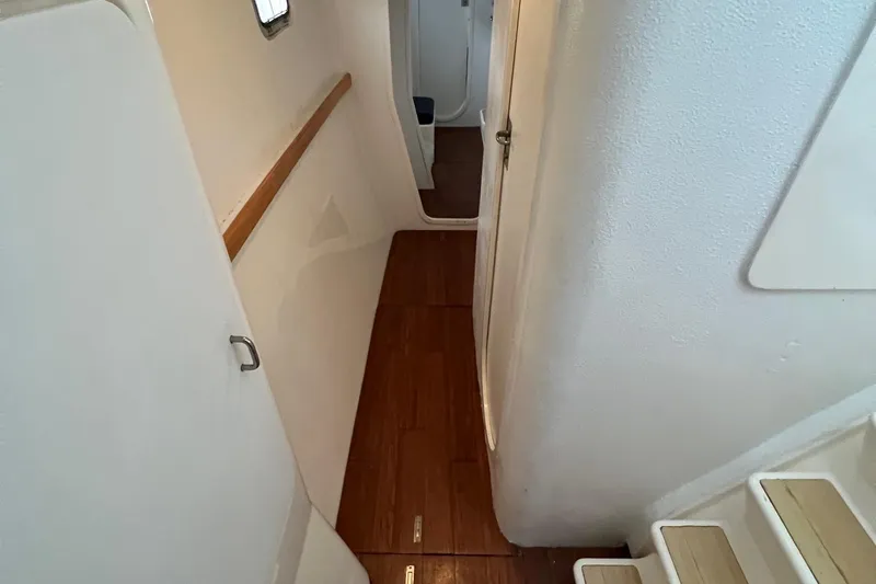 Seapaws Yacht Photos Pics Interior hallway of 1996 Voyage Yachts 470 with wooden flooring and white walls.