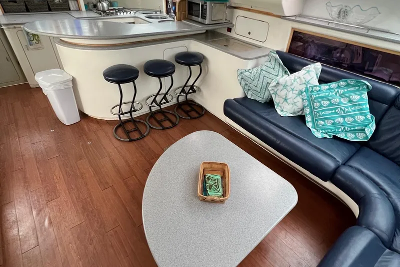 Seapaws Yacht Photos Pics Interior of 1996 Voyage Yachts 470 with modern kitchen and cozy seating area.