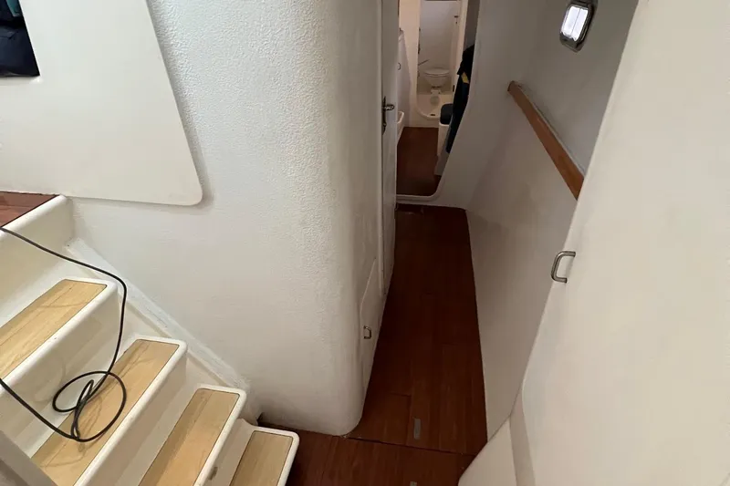 Seapaws Yacht Photos Pics Interior hallway of 1996 Voyage Yachts 470 with wooden flooring and white walls.