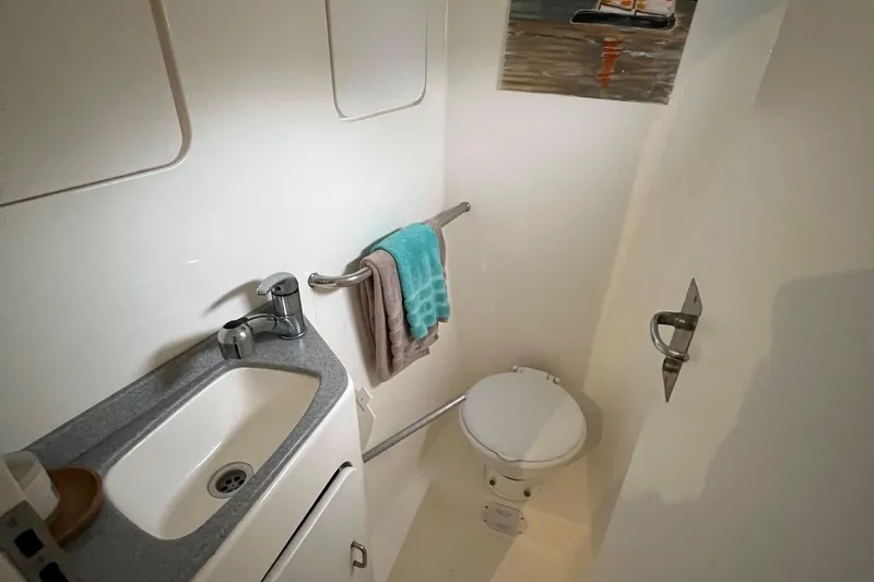 Seapaws Yacht Photos Pics Compact bathroom in a 1996 Voyage Yachts 470, featuring a sink, toilet, and towel rack.