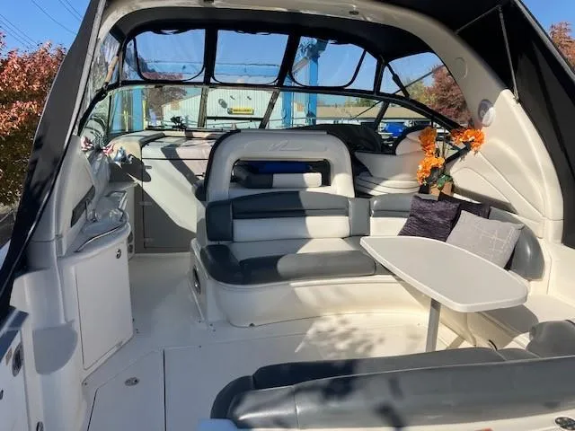  Yacht Photos Pics 2003 Sea Ray 420 Sundancer interior with seating and table, featuring modern design elements.