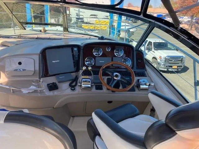  Yacht Photos Pics 2003 Sea Ray 420 Sundancer helm with steering wheel and navigation controls.