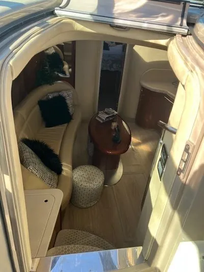  Yacht Photos Pics Interior of 2003 Sea Ray 420 Sundancer yacht with cozy seating and wooden table.