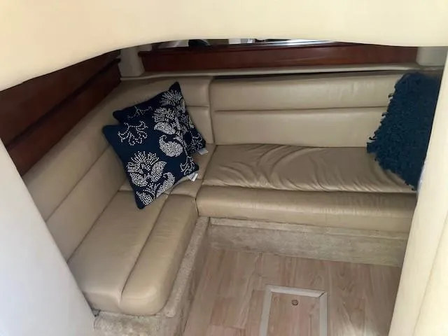  Yacht Photos Pics Luxurious interior of 2003 Sea Ray 420 Sundancer with beige leather seating and decorative pillows.