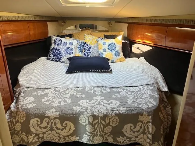  Yacht Photos Pics Luxurious cabin interior of 2003 Sea Ray 420 Sundancer with elegant bedding.
