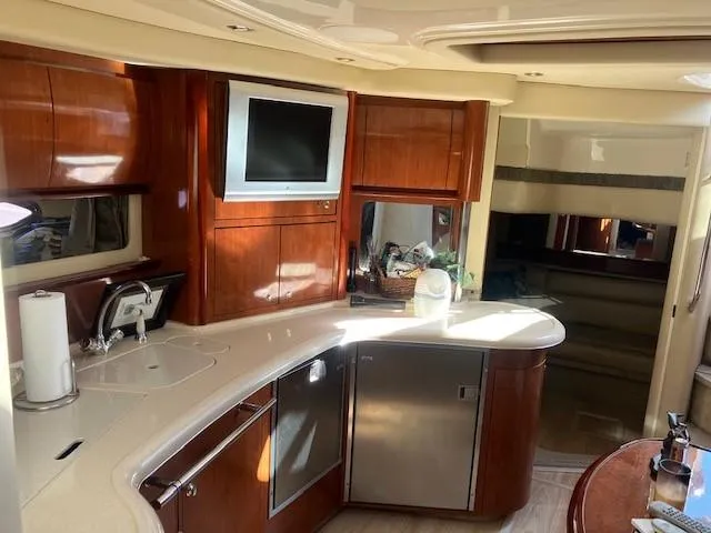  Yacht Photos Pics Luxurious interior of 2003 Sea Ray 420 Sundancer yacht with modern kitchen amenities.