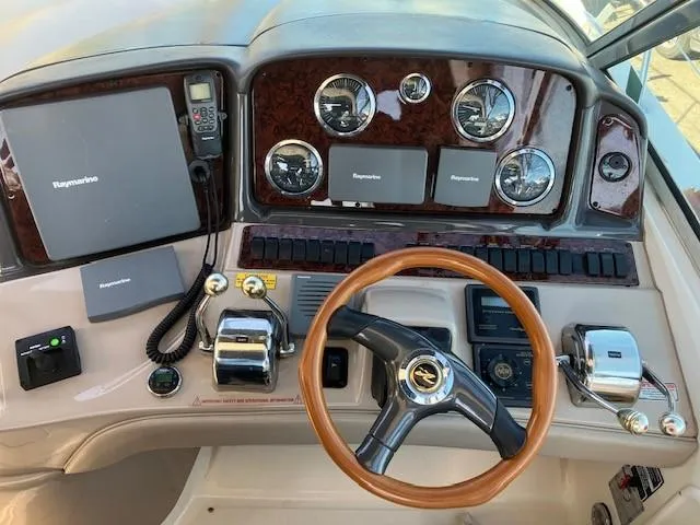  Yacht Photos Pics Cockpit of 2003 Sea Ray 420 Sundancer with steering wheel and navigation instruments.
