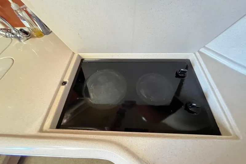 Jus A Lil' Yacht Photos Pics 2003 Searay 380 yacht kitchen with a sleek black stovetop.