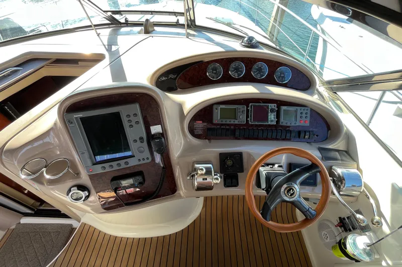 Jus A Lil' Yacht Photos Pics Cockpit of 2003 Searay 380 boat with navigation instruments and wooden steering wheel.