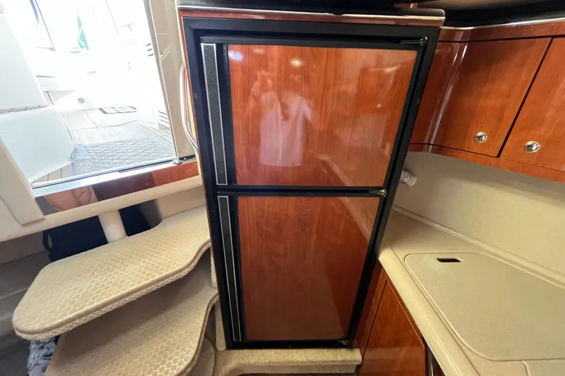 Jus A Lil' Yacht Photos Pics 2003 Searay 380 yacht interior with wooden cabinetry and compact refrigerator.